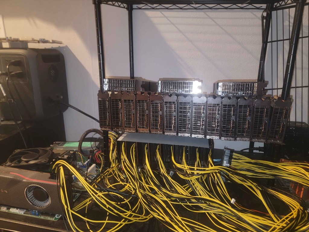 A DIY multi-GPU rack on a wire shelf, tangled in power cables